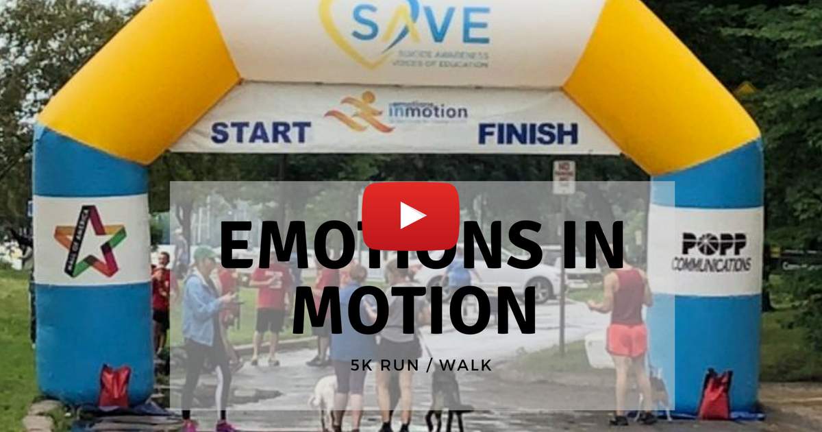 Runners gather under an inflatable arch labeled "START" and "FINISH" at a 5K event called "Emotions in Motion," with sponsor logos, including Choices Psychotherapy, promoting mental health services visible on the arch.