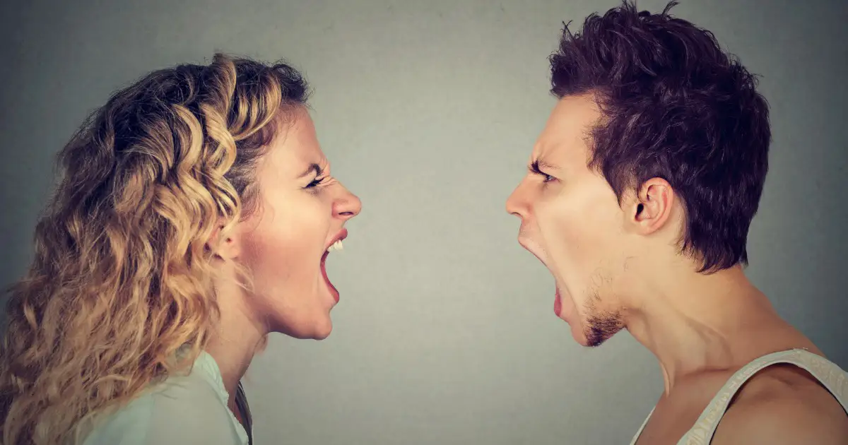 A woman and a man face each other, both with mouths open wide as if yelling or arguing, anxiety and financial stress evident in their tense expressions, against a neutral background.